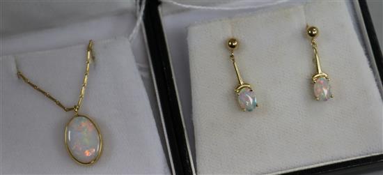 An 18ct gold and opal pendant on chain and a similar pair of opal and 14ct gold earrings.